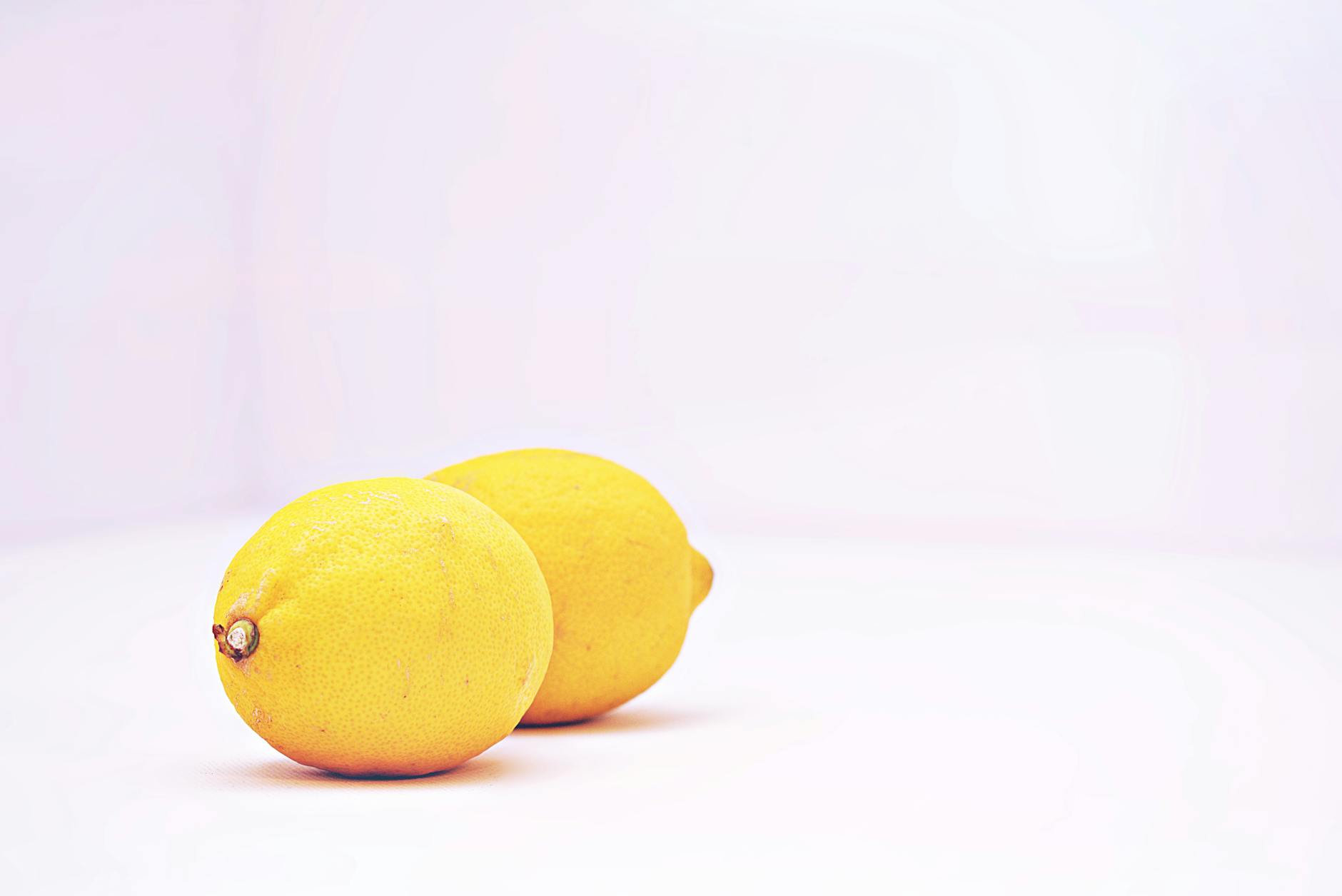 Three colorful lemon vibrators arranged on white fabric, highlighting smooth texture and design