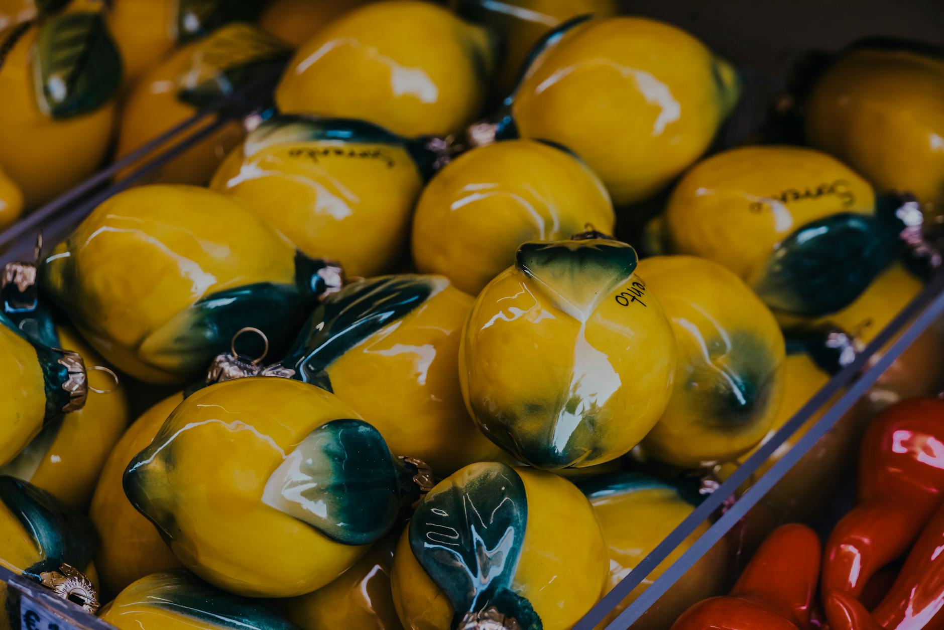 Yellow silicone lemon vibrator on yellow background with fresh fruit