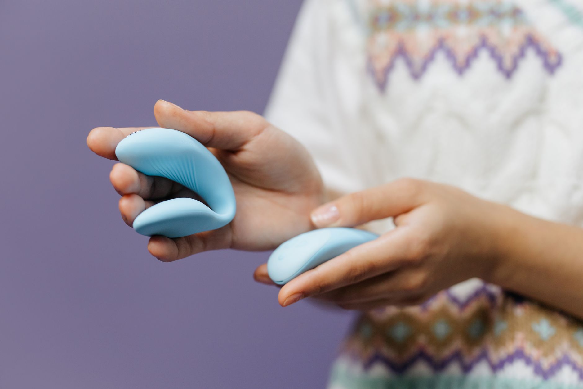 Close-up of hands holding a sleek vibrator, representing intimate reconnection during depression recovery.